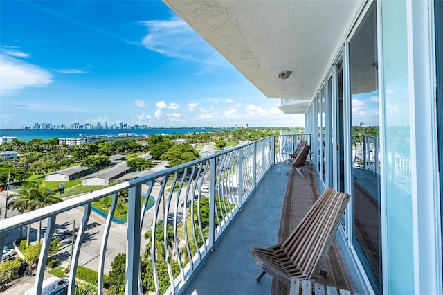 balcony with a water view and a city view