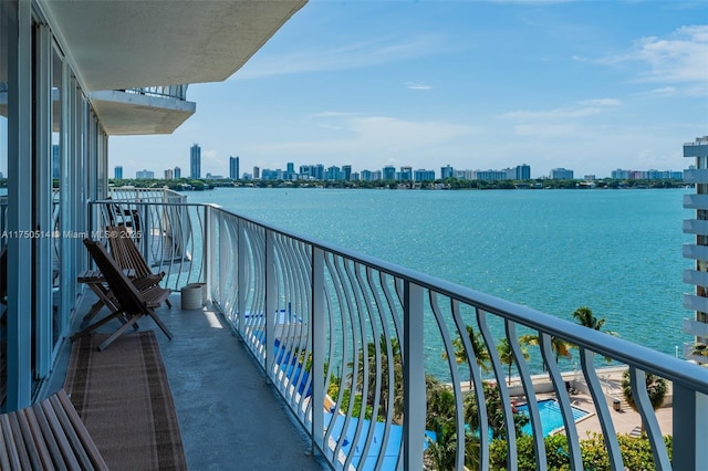 balcony with a water view and a city view