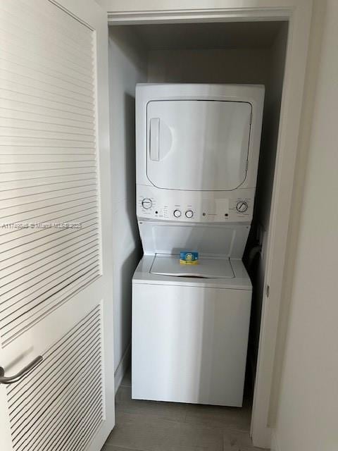 washroom with laundry area and stacked washer / dryer