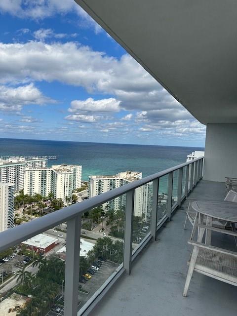 balcony featuring a water view