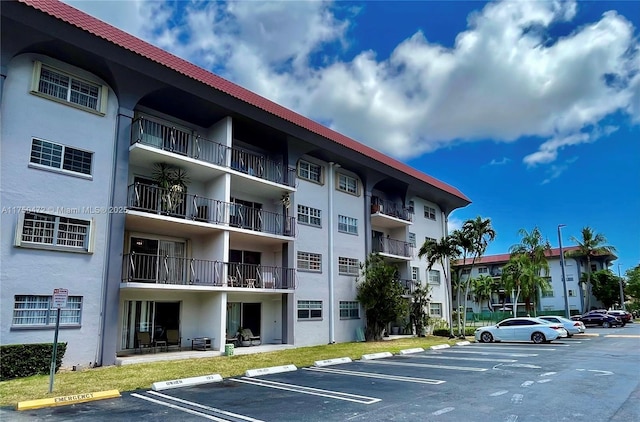 view of building exterior featuring uncovered parking