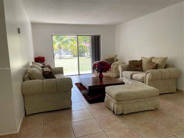 living room featuring a textured ceiling and light tile patterned flooring