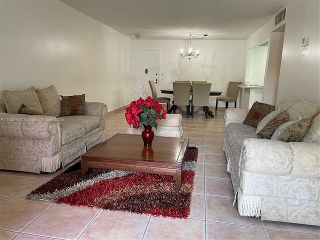 living area featuring visible vents, tile patterned floors, and a chandelier