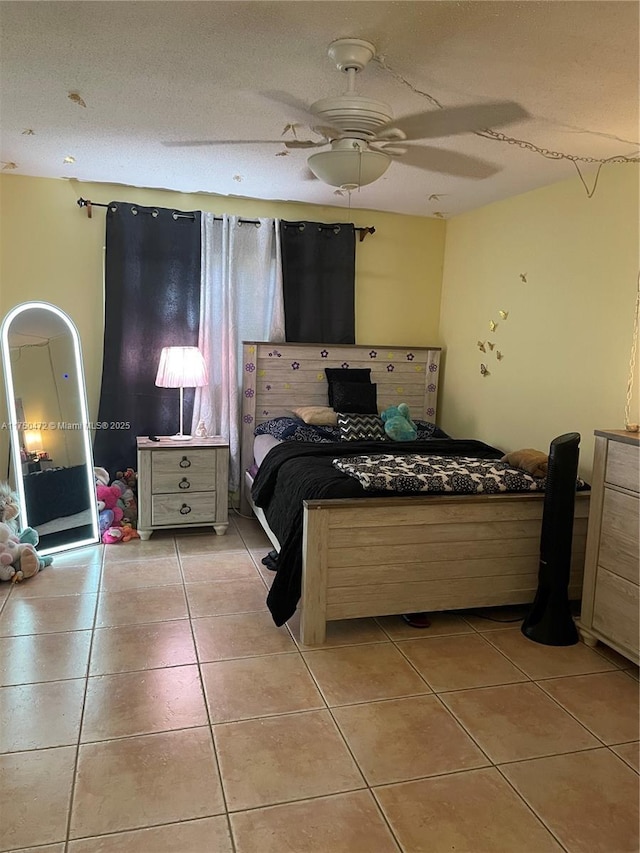 bedroom with ceiling fan and light tile patterned flooring