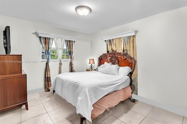 bedroom featuring light tile patterned flooring and baseboards