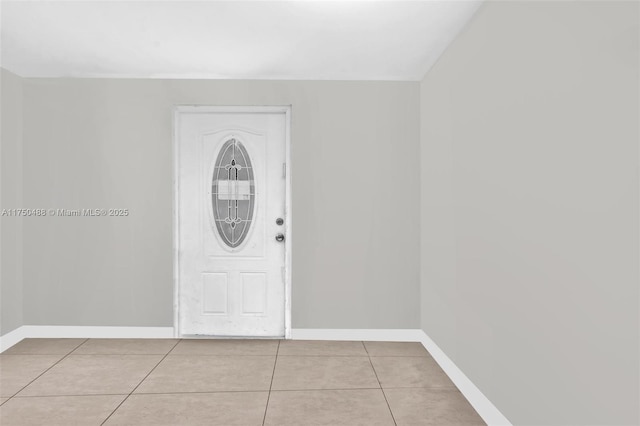 entryway with light tile patterned flooring and baseboards