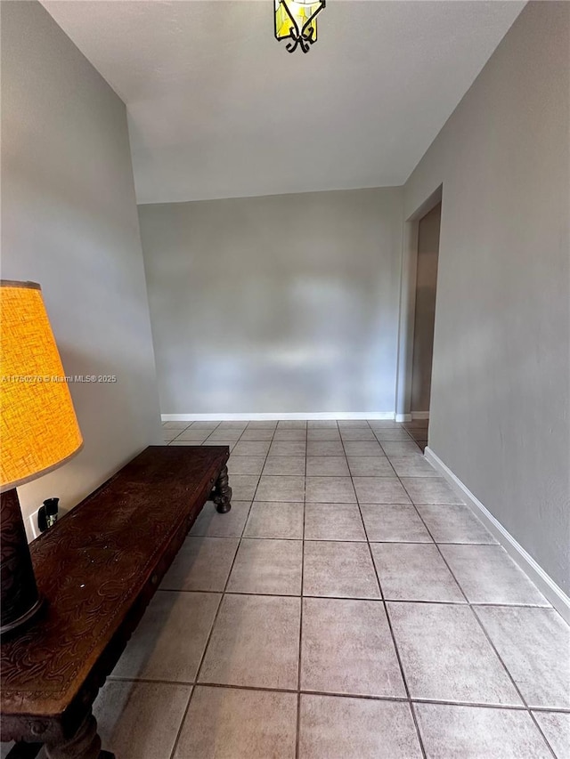 interior space with tile patterned flooring and baseboards