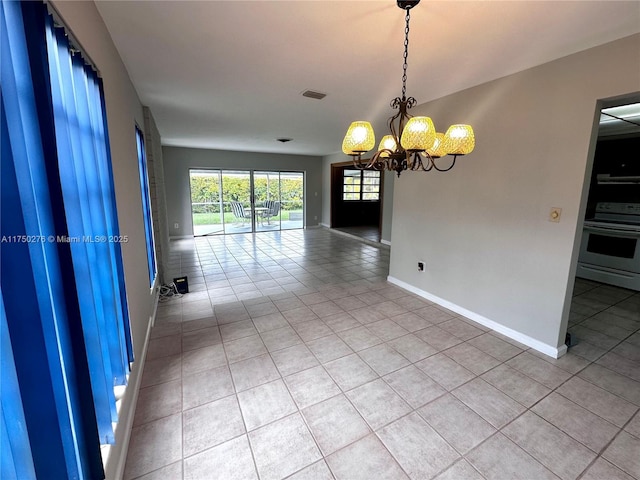 empty room with tile patterned flooring, visible vents, baseboards, and an inviting chandelier