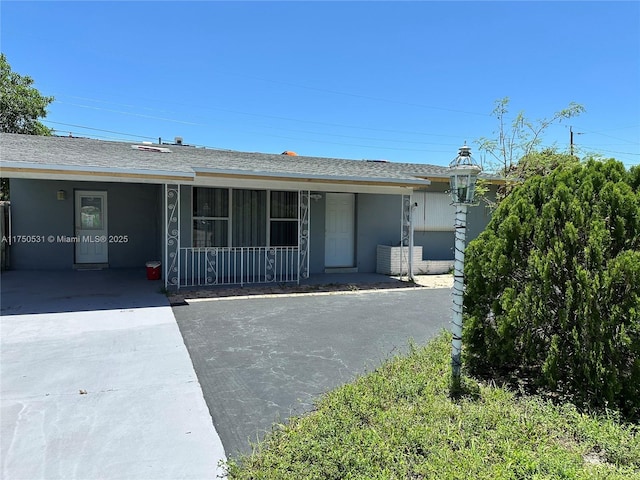 ranch-style house with covered porch and stucco siding