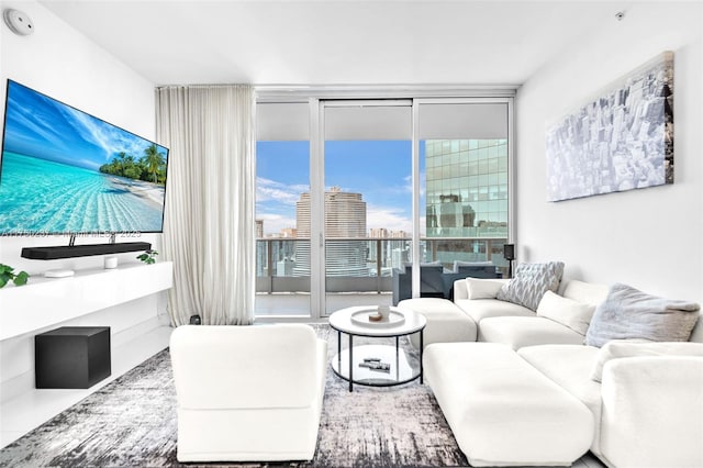 living room featuring a wall of windows and a city view