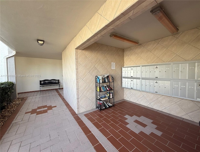 interior space featuring brick floor and mail area