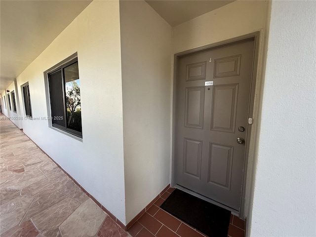 view of exterior entry with stucco siding