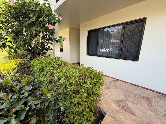 view of exterior entry with stucco siding