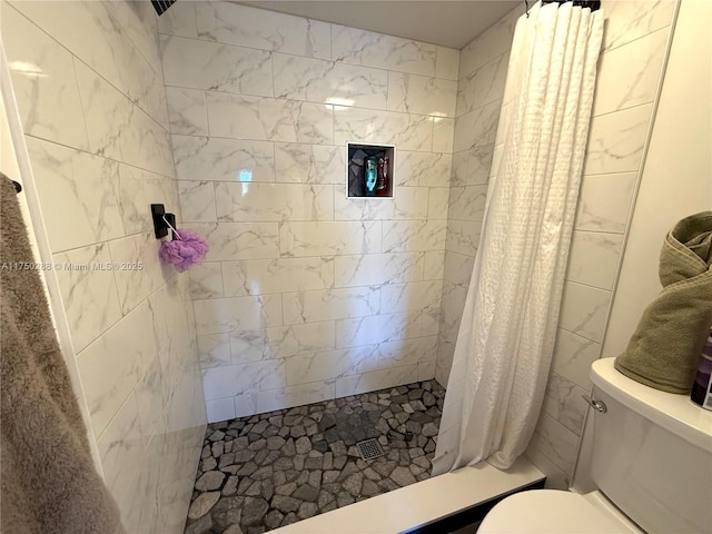 full bath with toilet and a stall shower