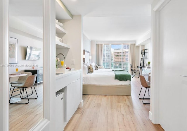 bedroom featuring light wood-style floors