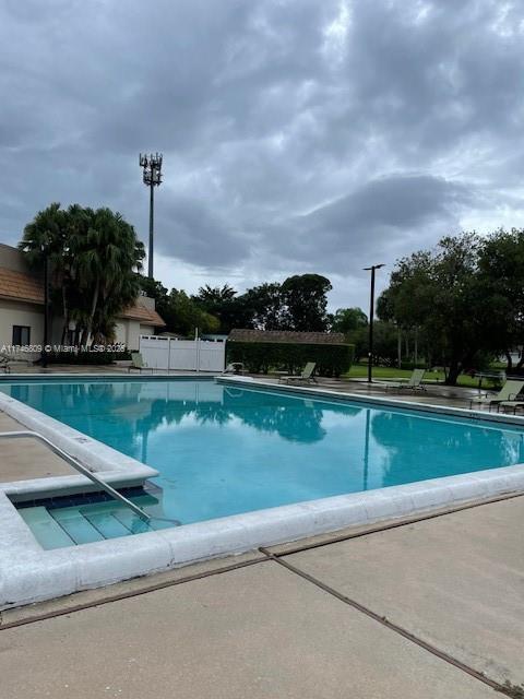 community pool featuring fence