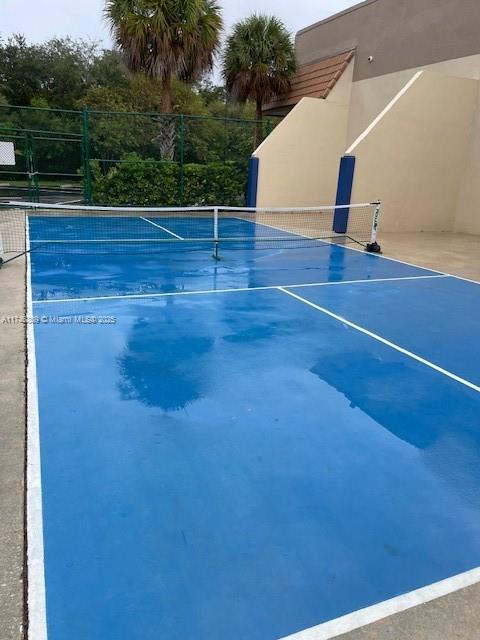 view of sport court with fence