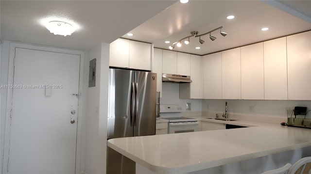 kitchen featuring a peninsula, a sink, white cabinets, light countertops, and white electric range oven