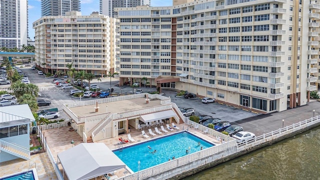 birds eye view of property with a water view and a city view