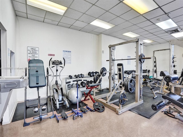 exercise room with visible vents and a paneled ceiling