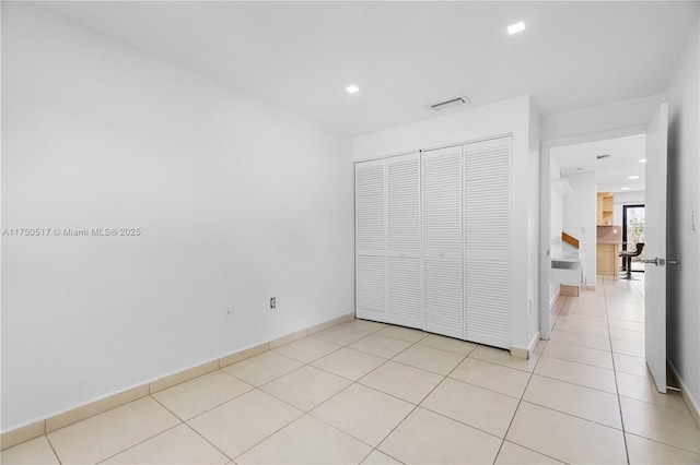 unfurnished bedroom featuring recessed lighting, baseboards, visible vents, and light tile patterned flooring