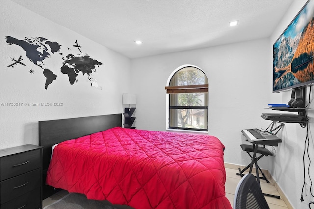 bedroom with a textured ceiling, recessed lighting, and baseboards