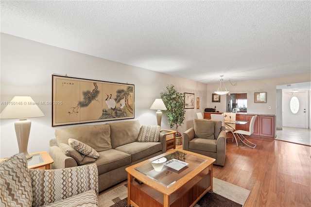 living area with a textured ceiling and wood finished floors