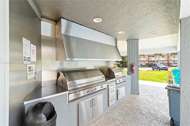 view of patio / terrace featuring an outdoor kitchen and a grill