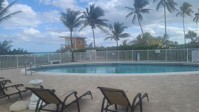 pool featuring a patio and fence