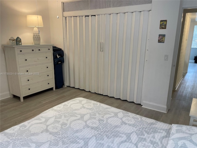 bedroom featuring light wood-style floors and baseboards