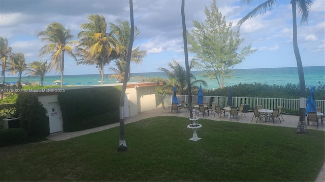 view of yard featuring a patio, central AC unit, a water view, and fence