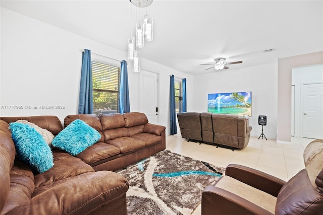 tiled living room with visible vents and a ceiling fan