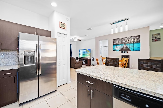 kitchen featuring dark brown cabinets, backsplash, open floor plan, light tile patterned floors, and stainless steel appliances