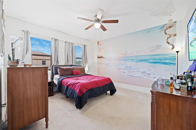 bedroom featuring baseboards, ceiling fan, and carpet