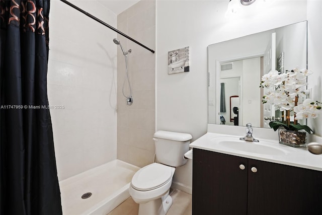 full bathroom featuring toilet, vanity, and tiled shower