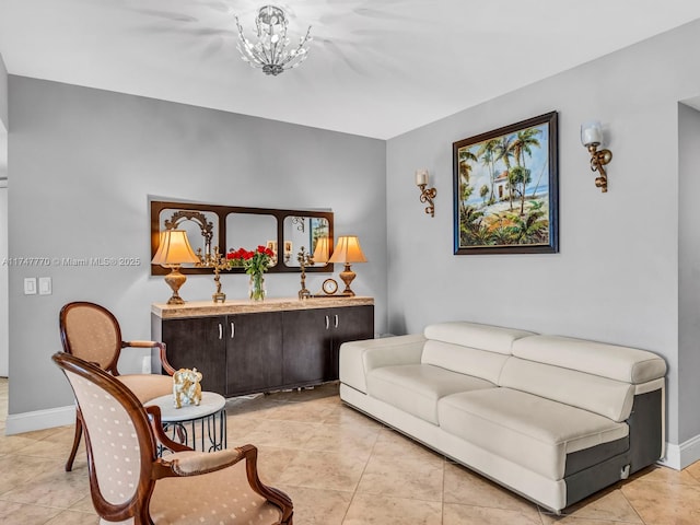 21205 Yacht Club Dr Unit 601, Aventura, FL 33180 - living room with an inviting chandelier, light tile patterned floors, and baseboards