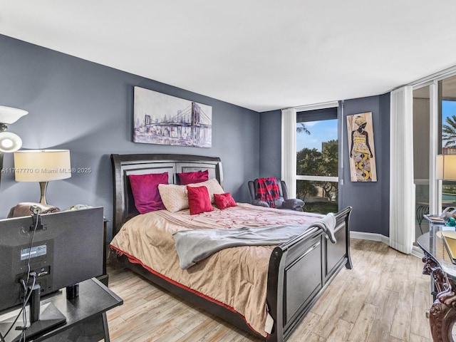 21205 Yacht Club Dr Unit 601, Aventura, FL 33180 - bedroom with floor to ceiling windows, baseboards, and wood finished floors
