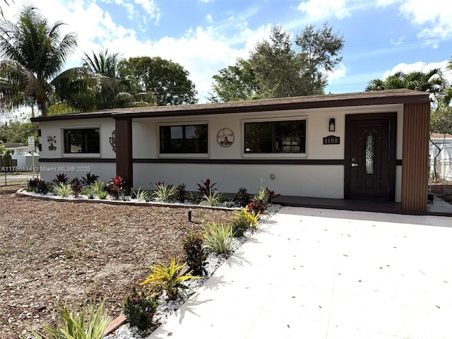 ranch-style house with stucco siding