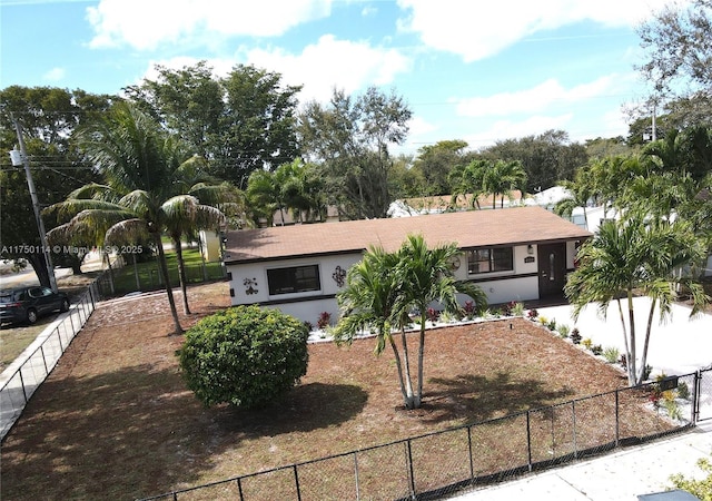 ranch-style house with a fenced front yard and stucco siding