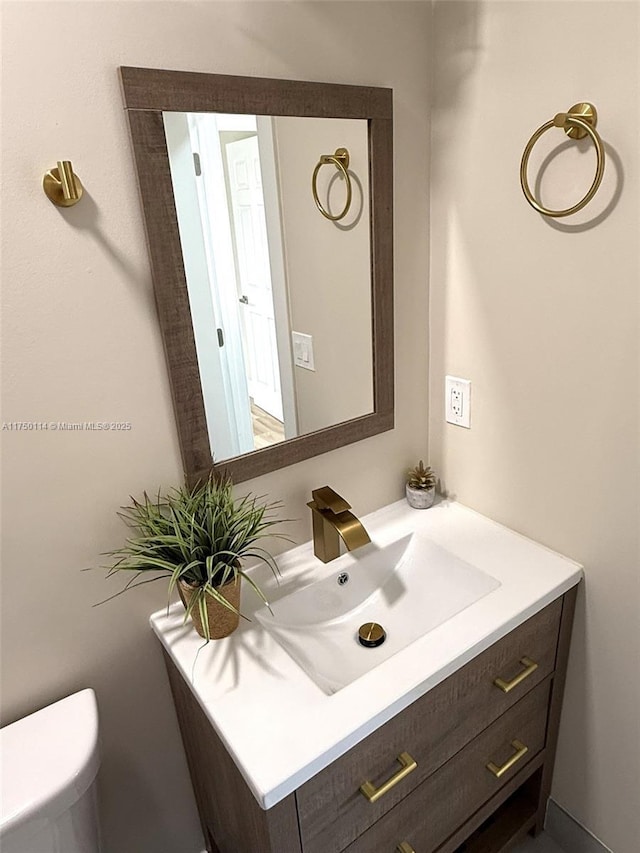 half bathroom with toilet and vanity