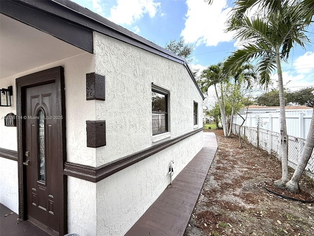 view of home's exterior featuring fence and stucco siding