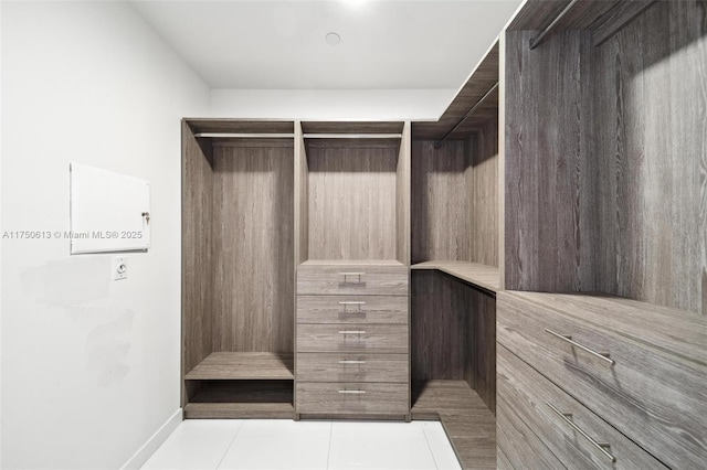 spacious closet featuring light tile patterned floors