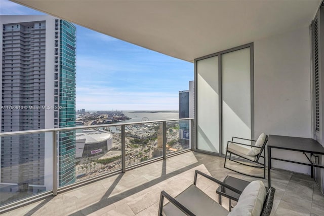 balcony featuring a city view and a water view