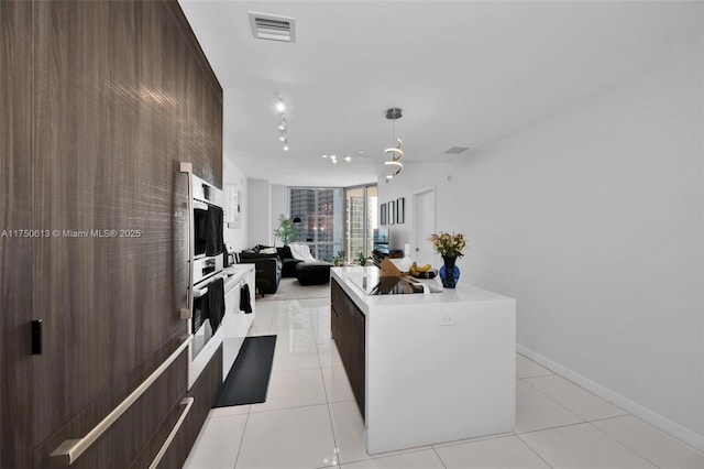 kitchen featuring light tile patterned floors, open floor plan, visible vents, and modern cabinets