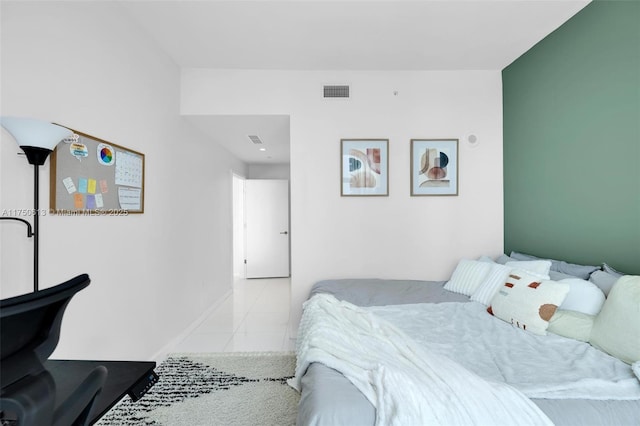 bedroom featuring light tile patterned flooring, visible vents, and baseboards