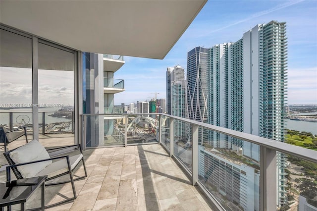 balcony featuring a view of city and a water view