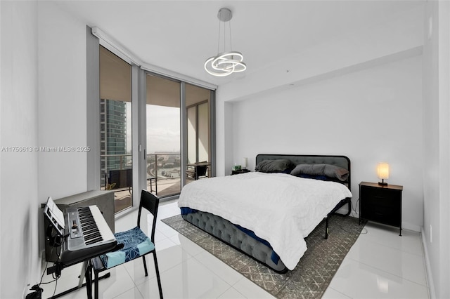 bedroom featuring a wall of windows, access to exterior, light tile patterned flooring, and baseboards