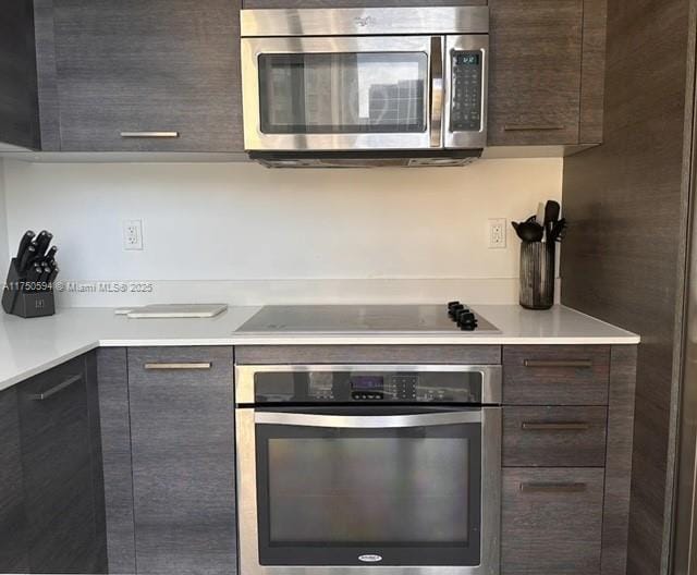 kitchen featuring light countertops, appliances with stainless steel finishes, and dark brown cabinetry