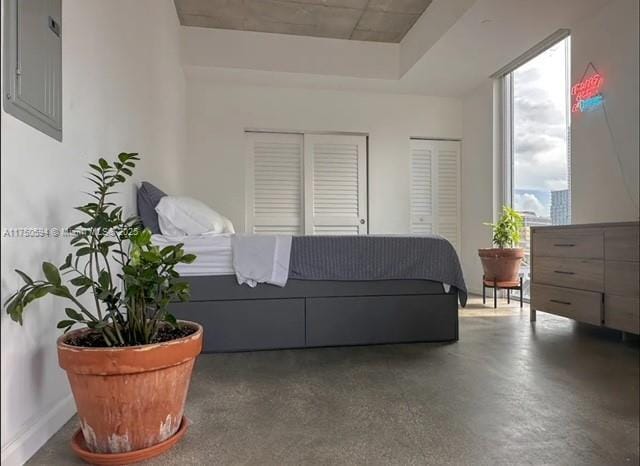 living room featuring electric panel and baseboards