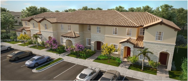 mediterranean / spanish house featuring uncovered parking, stone siding, a tiled roof, and stucco siding